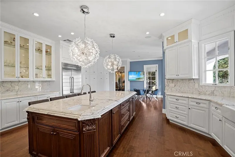 Kitchen with walnut island and glass-front cabinetry at One Zoom Listing
