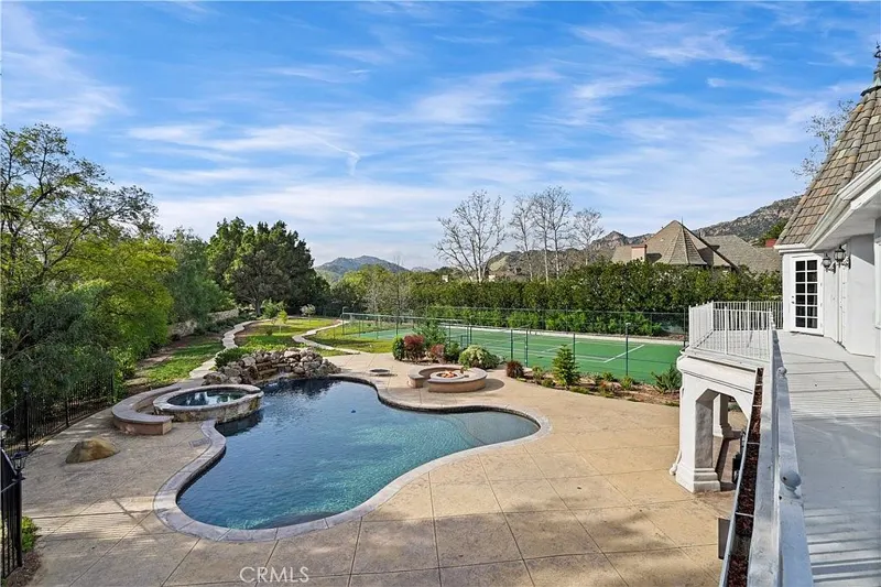 Daytime view over pool, spa and sport court at One Zoom Listing
