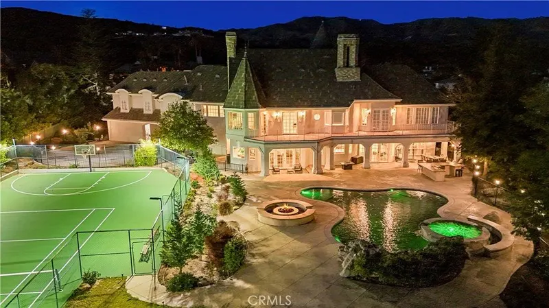 Aerial of the pool, spa and terraces at night at One Zoom Listing
