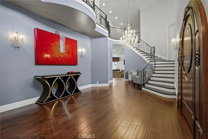 Two-story entry foyer with curved staircase at One Zoom Listing