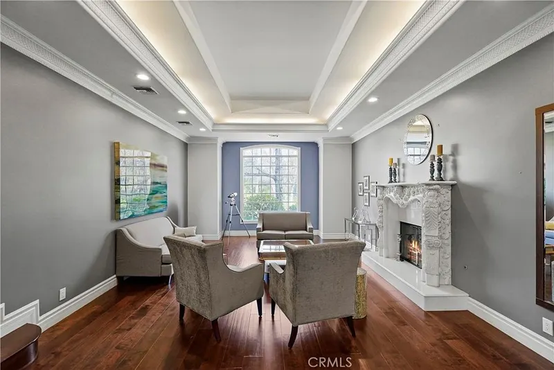 Sitting room with carved marble fireplace at One Zoom Listing