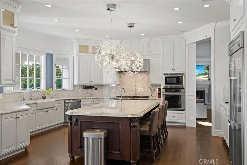 Chef's kitchen with marble island and dandelion pendants at One Zoom Listing
