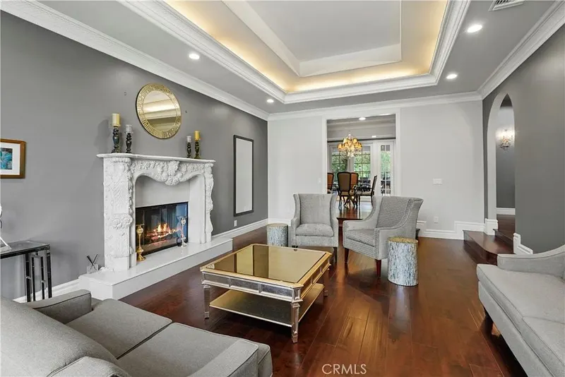 Formal living room beneath a lit tray ceiling at One Zoom Listing