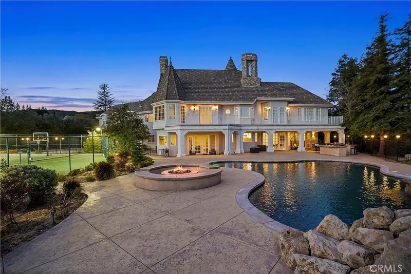 Pool, fire pit and rear loggia at blue hour at One Zoom Listing