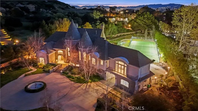 Aerial of the estate and sport court above the valley at One Zoom Listing