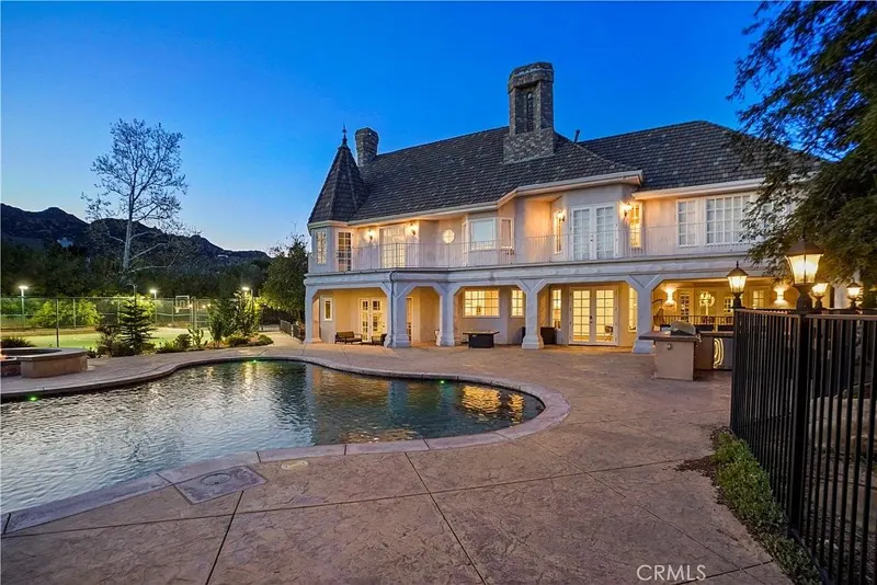 Pool deck and illuminated rear elevation at One Zoom Listing