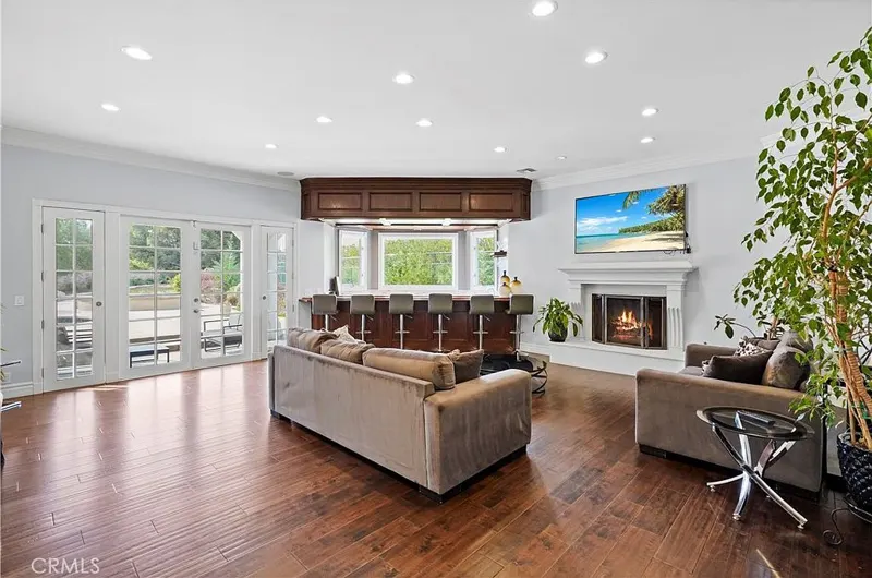 Family room with fireplace, wet bar and garden doors at One Zoom Listing
