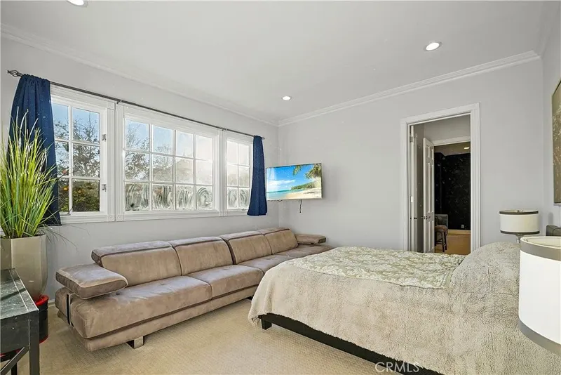 Guest bedroom suite with lounge seating at One Zoom Listing