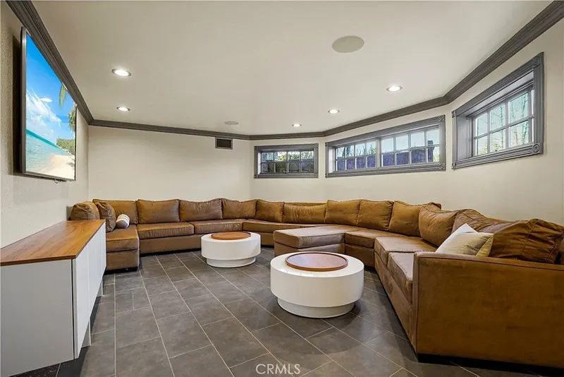 Lounge with wraparound sectional and bay windows at One Zoom Listing