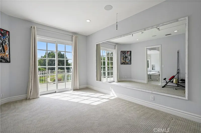 Bonus room with mirrored wall and garden access at One Zoom Listing